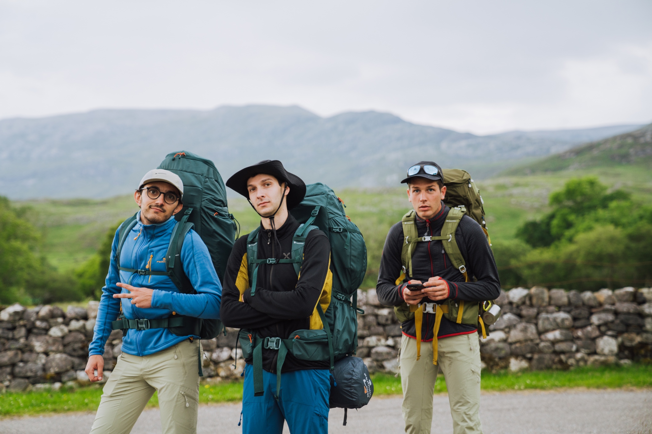 three backpackers ready for hiking