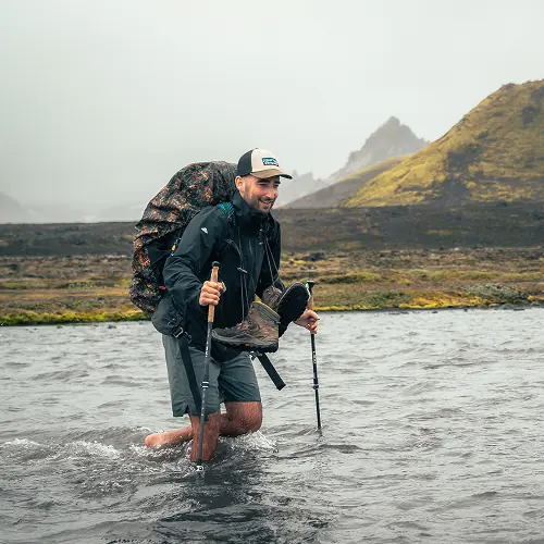 Hiker wading in water