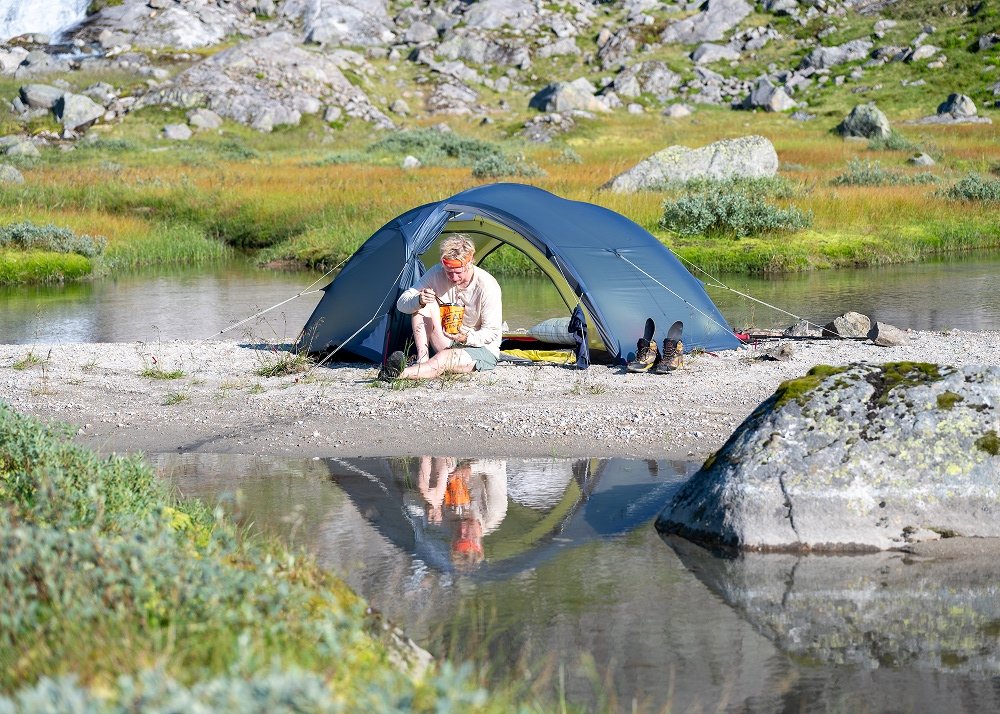 guy camping by the river